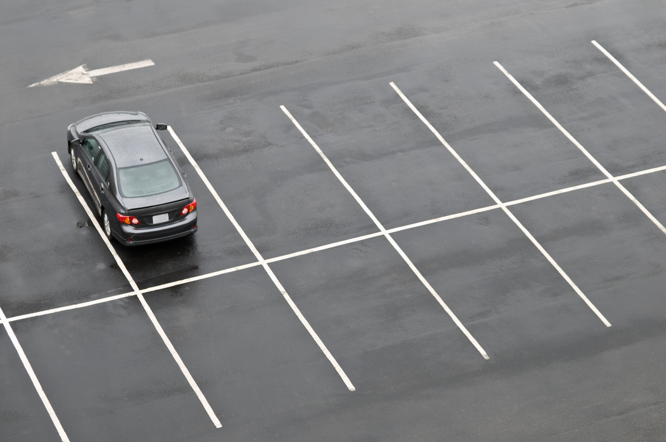 single car in empty parking lot